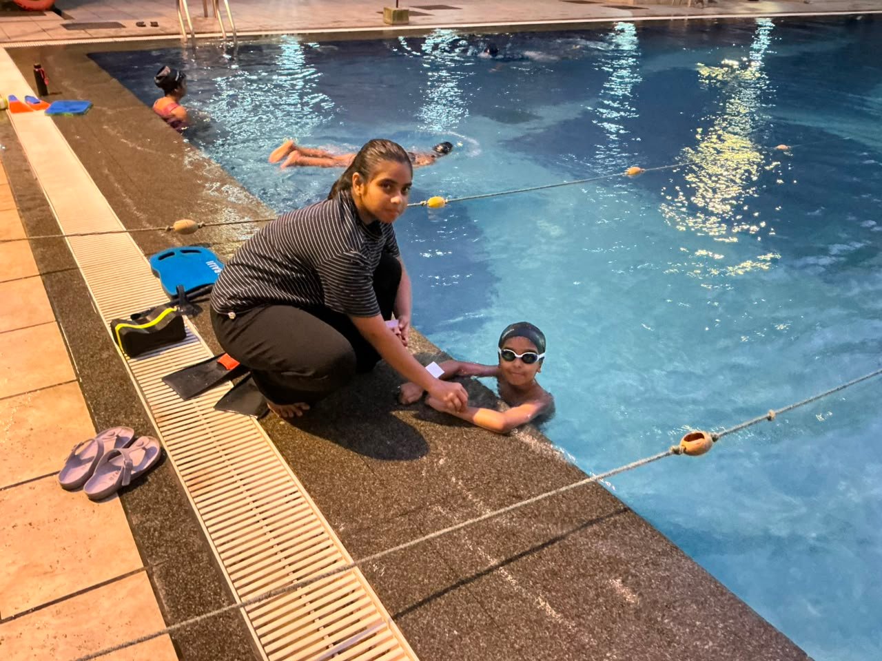 Fitting the sensor patch on a young swimmer poolside